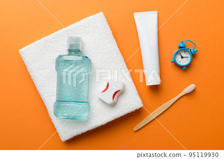 Mouthwash and other oral hygiene products on colored table top view with copy space. Flat lay. Dental hygiene. Oral care products and space for text on light background. concept 95119930