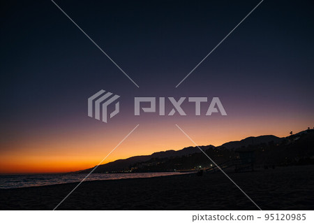 Will Rogers Beach State Park after beautiful sunset purple orange twilight in Los Angeles California. Cityscape background with text copy space Will Rogers Beach State Park after beautiful sunset purple orange twilight in Los Angeles California. Cityscape background with text copy space 95120985