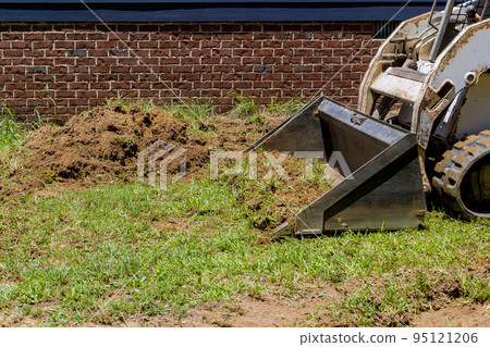 An earth moving is landscaping work in order to move earth using bulldozer scoop An earth moving is landscaping work in order to move earth using bulldozer scoop 95121206