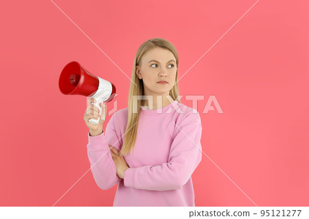 Young woman with megaphone on pink background 95121277