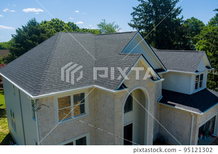 Roofing construction on a part of the new house covered in asphalt shingles Roofing construction on a part of the new house covered in asphalt shingles 95121302