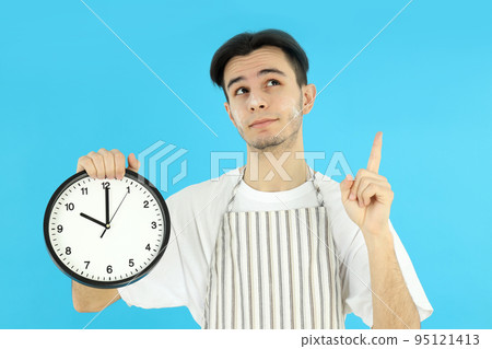 Concept of cooking, young man chef on blue background 95121413