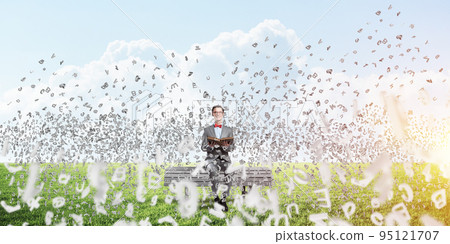 Young businessman or student studying the science and symbols fly around Young businessman or student studying the science and symbols fly around 95121707
