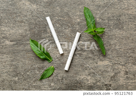 Menthol cigarettes and fresh mint leaves on colored background, Many cigarettes stacked together top view flat lay 95121763