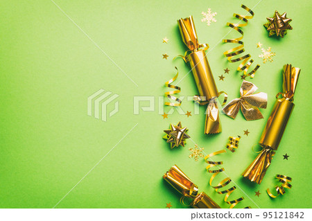 Christmas crackers with shiny confetti on color background, top view, copy space Christmas crackers with shiny confetti on color background, top view, copy space 95121842