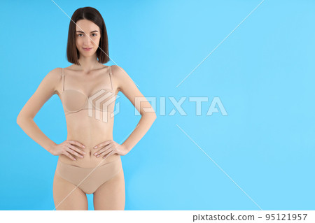 Concept of weight loss, young woman on blue background 95121957