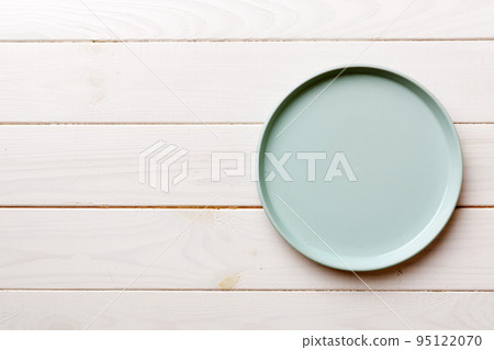Top view of empty blue plate on wooden background. Empty space for your design 95122070
