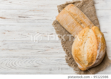 Assortment of freshly baked bread with napkin on rustic table top view. Healthy unleavened bread. French bread 95122086