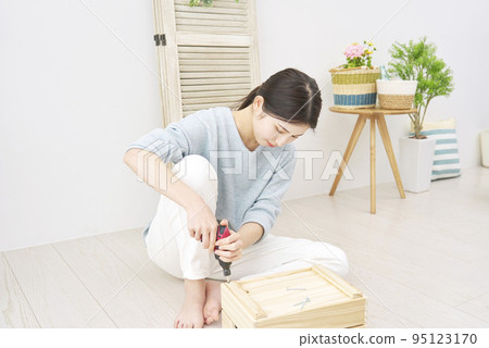 Woman doing DIY indoors Woman doing DIY indoors 95123170
