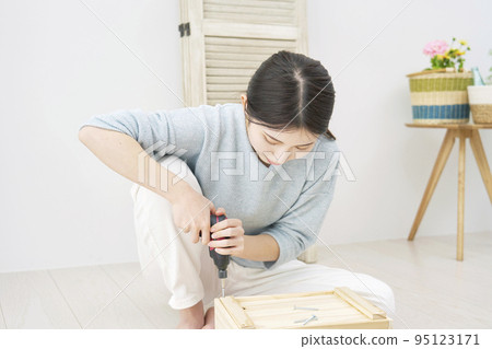 Woman doing DIY indoors Woman doing DIY indoors 95123171