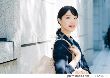 businesswoman walking in office 95123602