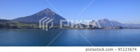 Pyramid shaped mountain Niesen seen from Beatenbucht, Switzerland. 95123674