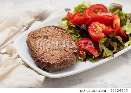 three fried ground meat with fresh salad on white plate three fried ground meat with fresh salad on white plate 95124235