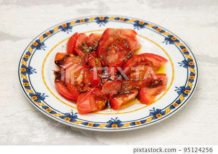 salad with fresh tomato and olive oil on the plate salad with fresh tomato and olive oil on the plate 95124256