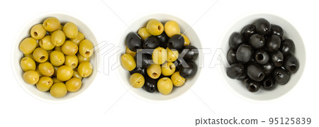 Pitted green and black olives, Hojiblanca, in white bowls, from above. European olives, Olea europaea, a cultivar from Lucena, Spain, mainly grown in Andalucia. Table olives with a lower oil content. Pitted green and black olives, Hojiblanca, in white bowls, from above. European olives, Olea europaea, a cultivar from Lucena, Spain, mainly grown in Andalucia. Table olives with a lower oil content. 95125839