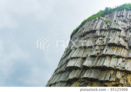 top of columnar volcanic basalt rocks on the island of Kunashir 95125906