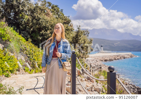 Woman tourist enjoying the views of Architecture and luxury yachts in Lustica Bay, Montenegro. Travel around Montenegro concept. Go Everywhere Woman tourist enjoying the views of Architecture and luxury yachts in Lustica Bay, Montenegro. Travel around Montenegro concept. Go Everywhere 95126007