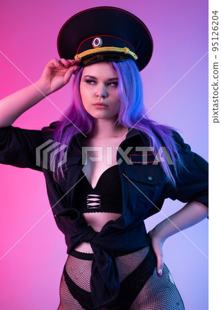Sexy girl in military or police uniform on a neon background translated from English - the police Sexy girl in military or police uniform on a neon background translated from English - the police 95126204