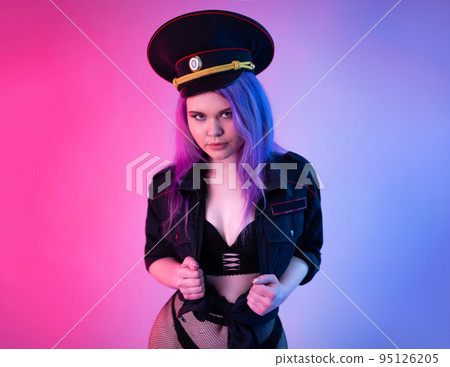 Sexy girl in military or police uniform on a neon background Sexy girl in military or police uniform on a neon background 95126205