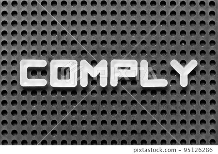 White alphabet letter in word comply on black pegboard background 95126286