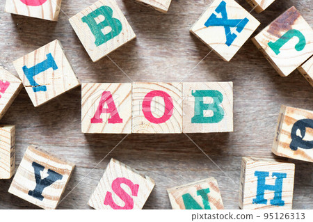 Alphabet letter block in word AOB (abbreviation of Assignment of benefits or Any other business) and another letter on wood background 95126313