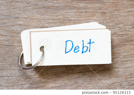 Flash card with handwriting in word debt on wood background Flash card with handwriting in word debt on wood background 95126315