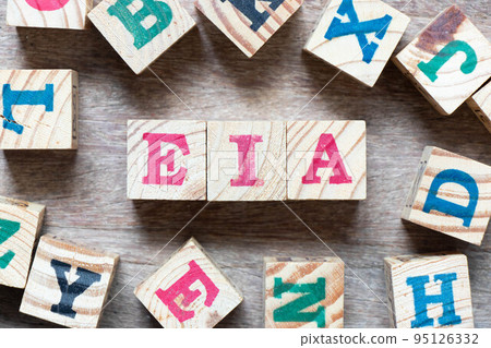 Alphabet letter block in word EIA (abbreviation of Environmental Impact Assessment) and another letter on wood background Alphabet letter block in word EIA (abbreviation of Environmental Impact Assessment) and another letter on wood background 95126332