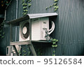 Outdoor unit with a roof behind an old private house 95126584