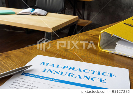 Table with Malpractice insurance application on it. 95127285