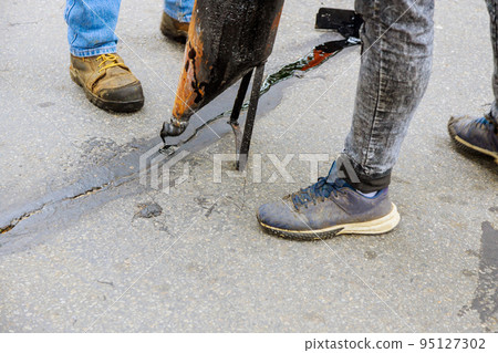 As part asphalt road surface restoration work crack in joint of asphaltic joint needs to be sealed As part asphalt road surface restoration work crack in joint of asphaltic joint needs to be sealed 95127302