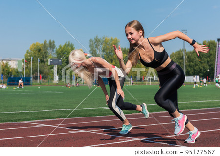 Two athlete woman runnner are training 95127567