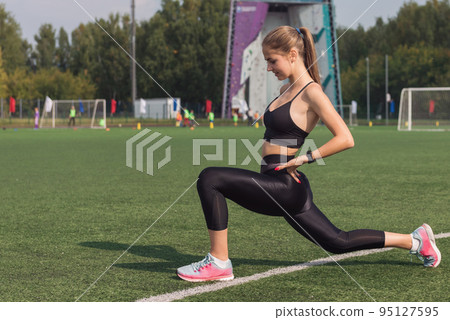 Young woman athlete is exercising Young woman athlete is exercising 95127595