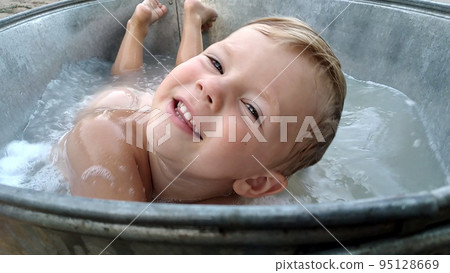 Smiling boy in the bathtub with foam. High quality photo 95128669