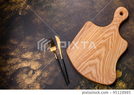 An empty brown ceramic plate on a dark concrete brown background 95128985