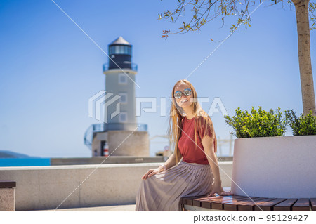Woman tourist enjoying the views of Architecture and luxury yachts in Lustica Bay, Montenegro. Travel around Montenegro concept. Go Everywhere Woman tourist enjoying the views of Architecture and luxury yachts in Lustica Bay, Montenegro. Travel around Montenegro concept. Go Everywhere 95129427