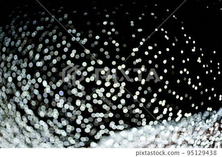 Abstract background of unfocused flickering white lights on an isolated black background. Holiday party concept, Christmas background. Overlay for your design. High quality photo 95129438