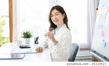 Office worker with a beautiful Asian woman in a private office, Daily routine of office workers, Welcome to work in the morning with a bright smile, Businesswoman in office concept. Office worker with a beautiful Asian woman in a private office, Daily routine of office workers, Welcome to work in the morning with a bright smile, Businesswoman in office concept. 95129521