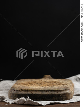 Empty wooden cutting board on black table, food display template Empty wooden cutting board on black table, food display template 95130241