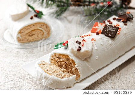 White chocolate yule log cake with ornament 95130589