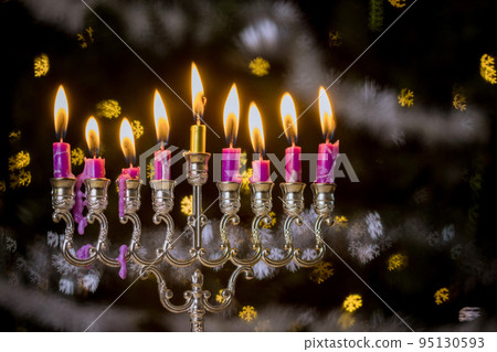 Jewish Religion holiday symbol for Hanukkah in Hanukkiah Menorah burned candles on lit blurred bokeh Jewish Religion holiday symbol for Hanukkah in Hanukkiah Menorah burned candles on lit blurred bokeh 95130593