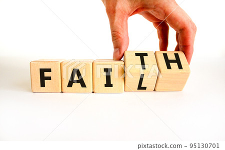Faith instead fail symbol. Businessman turns wooden cubes and changes the concept word Fail to Faith. Beautiful white table white background. Business and faith instead fail concept. Copy space. Faith instead fail symbol. Businessman turns wooden cubes and changes the concept word Fail to Faith. Beautiful white table white background. Business and faith instead fail concept. Copy space. 95130701