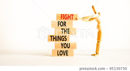 Fight for love symbol. Concept words Fight for the things you love on wooden blocks on a beautiful white table white background. Businessman icon. Business motivational and fight for love concept. 95130730