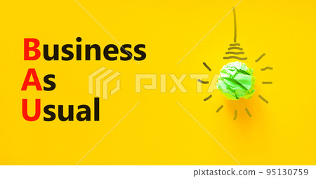 BAU business as usual symbol. Concept words BAU business as usual on a beautiful yellow background. Green light bulb icon. Business and BAU business as usual concept. Copy space. BAU business as usual symbol. Concept words BAU business as usual on a beautiful yellow background. Green light bulb icon. Business and BAU business as usual concept. Copy space. 95130759