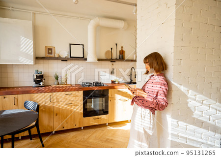 Woman with digital tablet at home Woman with digital tablet at home 95131265