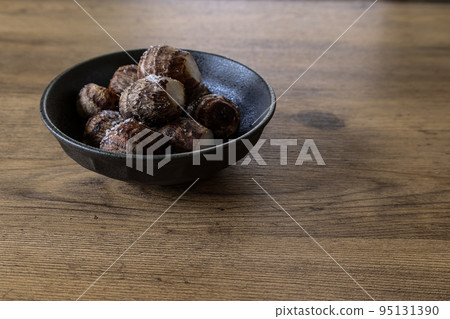 Kinukatsugi in a black dish on a wood background Kinukatsugi in a black dish on a wood background 95131390