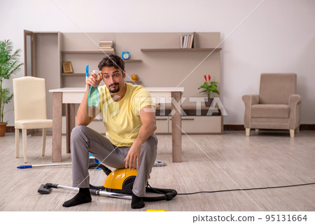 Young man doing housework at home 95131664