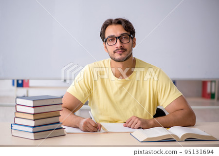 Young male student preparing for exams in the classroom 95131694