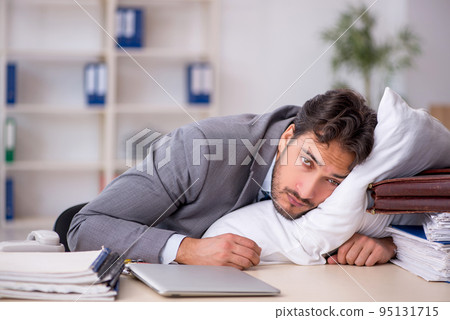Young male employee in oversleeping concept Young male employee in oversleeping concept 95131715