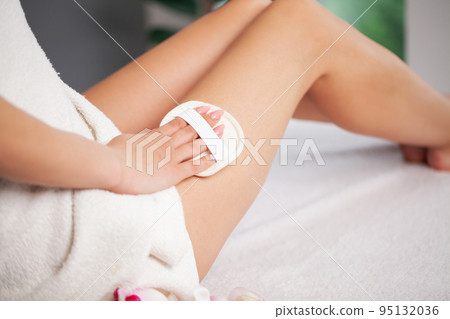 Woman brushing skin buttocks and leg with a dry brush to prevent and treatment cellulite. Woman brushing skin buttocks and leg with a dry brush to prevent and treatment cellulite. 95132036