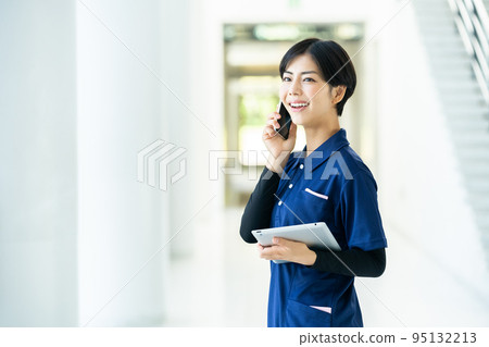 Caregiver operating a tablet 95132213